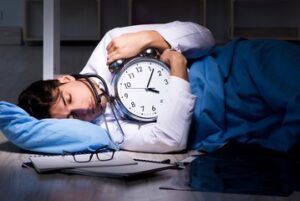 sleeping doctor with a wall clock